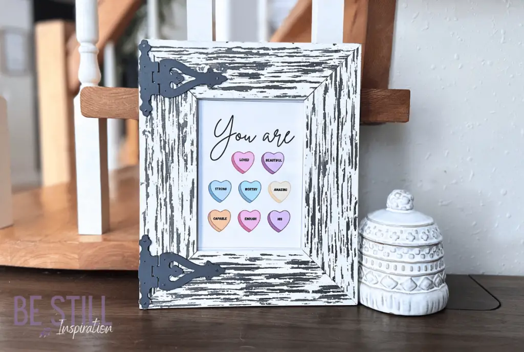 White rustic picture frame featuring candy hearts printable with winter hat candy dish.